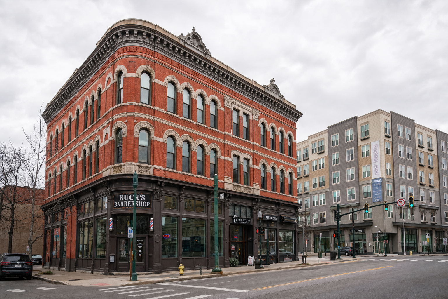 A restored 1900s brick apartment building in downtown Binghamton next to a modern beige apartment complex.